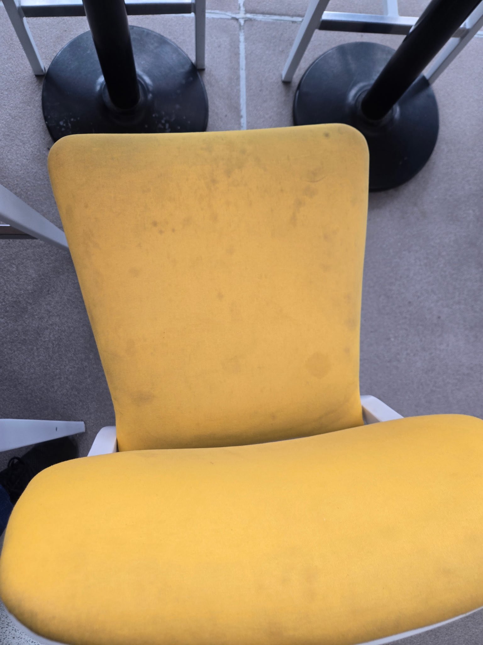 Yellow chair before cleaning — stained and dirty fabric
